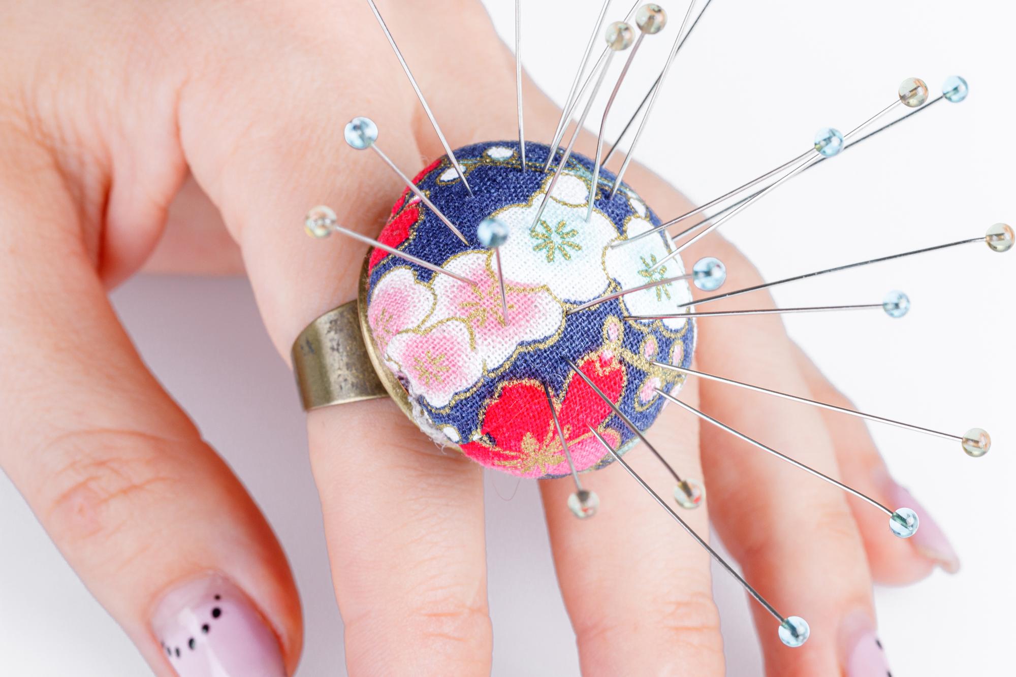 Woman doing hand embroidery over futuristic pattern